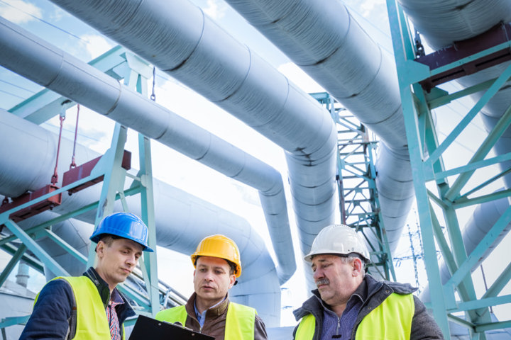 Engineers discussing maintenance of a petrochemical plant
