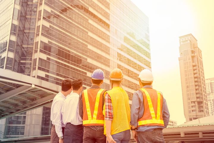Workers standing outside of a building.